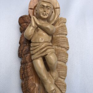 Hand-carved wooden figure of a praying child with detailed texture.
