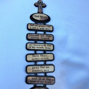Wooden plaque with the Hail Mary prayer and a cross at the top.