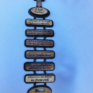 Wooden plaque with the Lord's Prayer engraved and a crucifix on top.