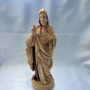 Carved statue of Jesus Christ with a heart symbol on his chest.